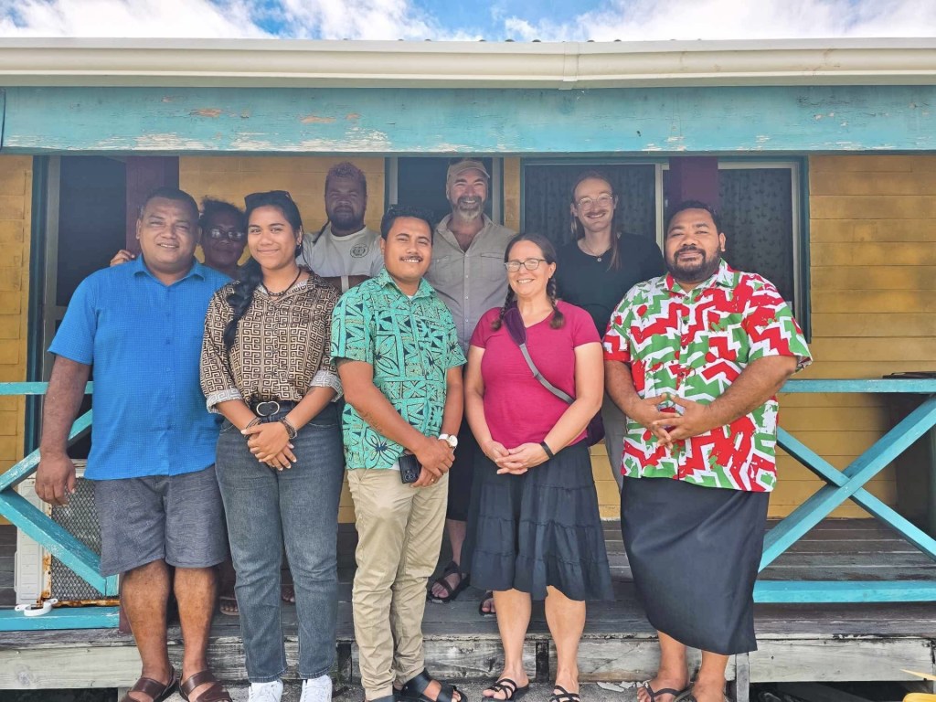 Tuvalu Climate Action network staff standing in front of a building with Brian and Becky Webb